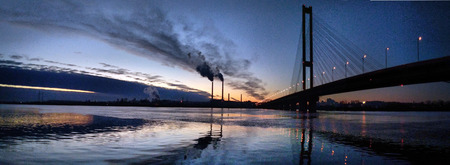 The South bridge at night, Kiev, Ukraine. Bridge at sunset across the Dnieper River. Kiev bridge against the backdrop of a beautiful sunset in Kiev. Bridge in evening sunshineの写真素材