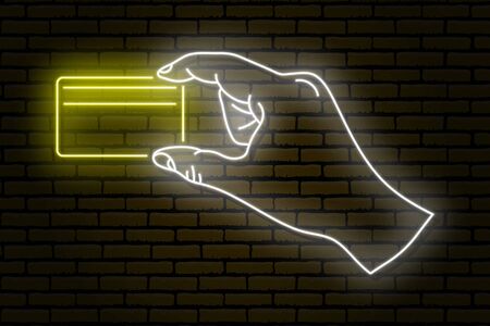 Neon sign. A human hand holding a gold plastic credit card with two fingers. Against a brick wall.のイラスト素材