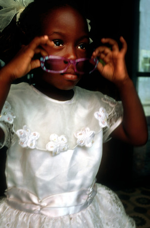 Little girl in Sunday best clothes on step in the street Havana Cubaのeditorial素材