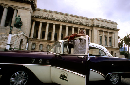 Old car 1950s Chevrolet passing the Capitolio Nacional, Havana, Cubaのeditorial素材