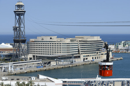 The Romantic route in Barcelona. Monjuic mountain.  View of Barcelona Harbour. The red Teleferic cable car running across Barcelona Port in Barcelona Spain It runs from the beach in Barceloneta to Mountjuic. Montjuic Cable Car Above Harbour, Barcelona.のeditorial素材