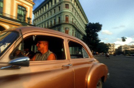 Old car 1950s Chevrolet passing the Saratoga Hotel, Paseo de Marti, Old Havana, Cubaのeditorial素材