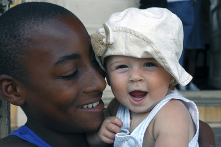 A Cuban adolescent boy in her arms a baby abroad, Trinity, Cuba.のeditorial素材