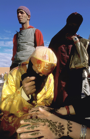 Woman applying a henna tattoo on a tourists hand in the Djemaa el-Fna market in Marrakech Moroccoのeditorial素材