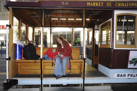 Classic view of historic traditional Cable Cars riding on famous California Street in beautiful morning light at sunrise in summer, San Francisco, USAのeditorial素材