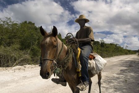 Cat Island, Bahamas. Man riding a horse in the East (Atlantic) area Pine Bay, Cat Island.のeditorial素材