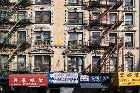 Building facades with fire escapes in China Town, New York City, USA.のeditorial素材