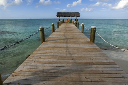 Wooden pier at Hotel Compass Point Resort at Love beach Nassau, Bahamas, Caribbean. Brightly Colored Cottages At Compass Point Beach Club.のeditorial素材