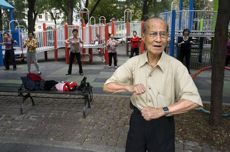 Chinese man practice Tai Chi in Seward Park in the newly trendy Lower East Side Chinatown neighborhood in NYC. WH Seward Park.のeditorial素材