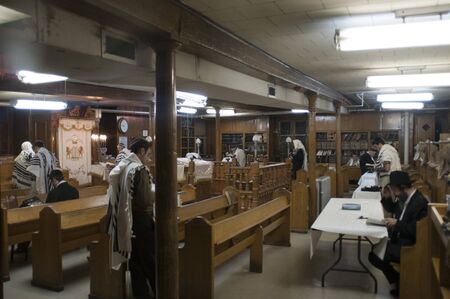 Torah reading at morning prayers inside Lubavitch headquarters in Crown Heights Brooklyn New York.