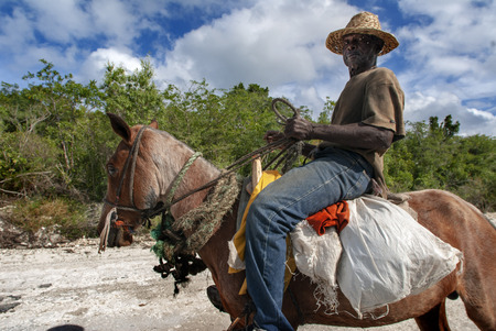 Cat Island, Bahamas. Man riding a horse in the East (Atlantic) area Pine Bay, Cat Island.のeditorial素材