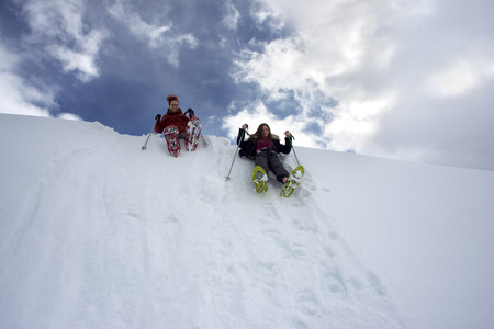 Baqueira Beret, Ski resort, Pyrenees, Aran Valley, Lleida, Catalonia, Spain. People walking with snow rackets towards the summit of a snowy hill.のeditorial素材