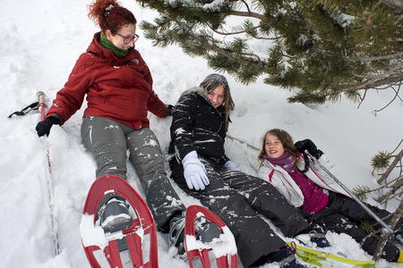 Baqueira Beret, Ski resort, Pyrenees, Aran Valley, Lleida, Catalonia, Spain. Family walking with snow rackets towards the summit of a snowy hill.のeditorial素材
