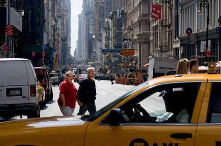 YELLOW TAXI CAB BROADWAY STREET SOHO MANHATTAN NEW YORK CITY USA. A taxi passes Soho up to Broadway...