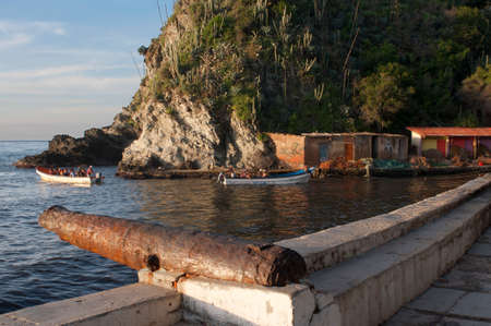 Malecon and cannon in Choroni beach in Falcon state in Venezuela - Henri Pittier National Park, in Venezuela.  It presents a big touristy interest, by being one of the starting points towards the islands of Morrocoy National Park, together with Tucacas.のeditorial素材