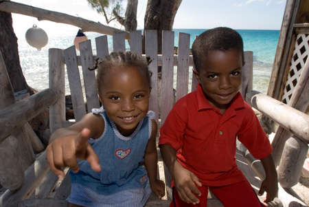 Children playing next to Seaside bar restaurant and cocktails in Arthur's Town, Cat Island, Bahamasのeditorial素材