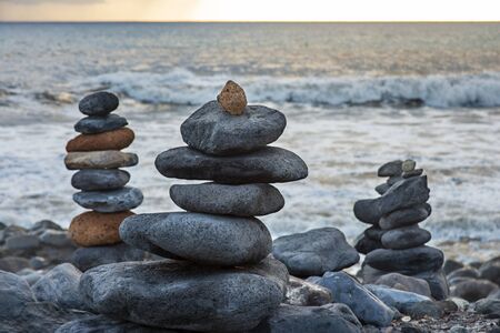 Art of stone balance or rock stones piles at Beach Playa de Caleta Tenerife Island, Canary Islands,...