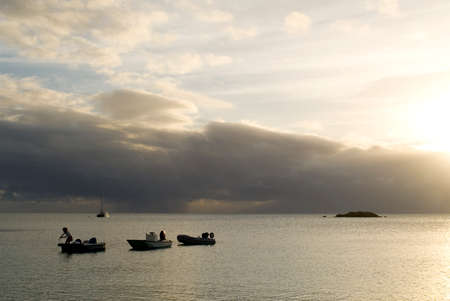 Sunset with a small boats. Beach Fernandez Bay Village, Cat Island. Bahamasのeditorial素材