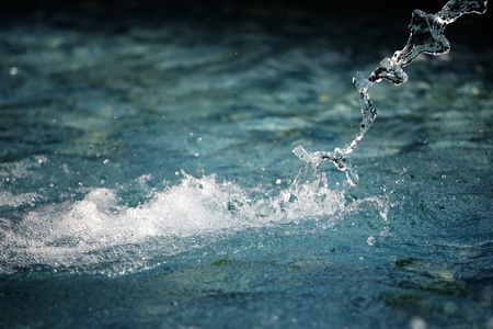 Water jet falls into the water and sprayed の写真素材