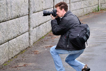 Photographer at work in search of interesting perspectiveの写真素材