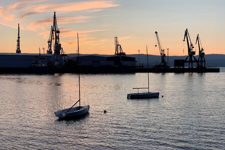 image of harbor cranes at port at sunset