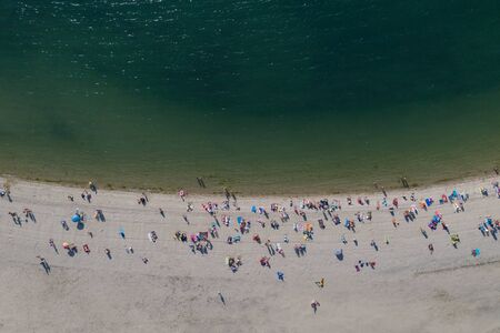 image of people having a rest on the sea beach, top view, shooting from droneの写真素材