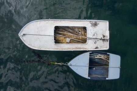 wooden fishing boats anchored in the sea, top view from droneの写真素材