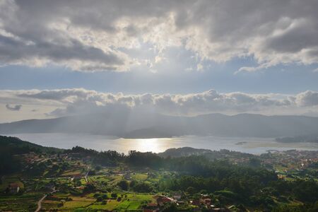 beautiful landscape sun through the clouds shines over the ocean bay