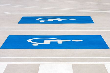 blue road sign disabled parking on asphalt in public parkingの写真素材
