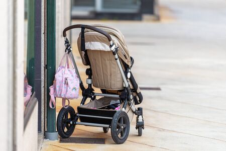 empty baby stroller near the store on the streetの写真素材
