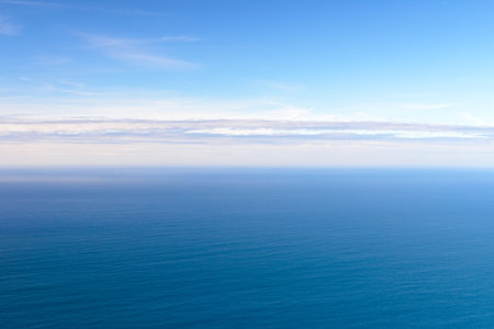 clear blue sea with clouds on the horizon, natural landscape, background, wallpaperの写真素材