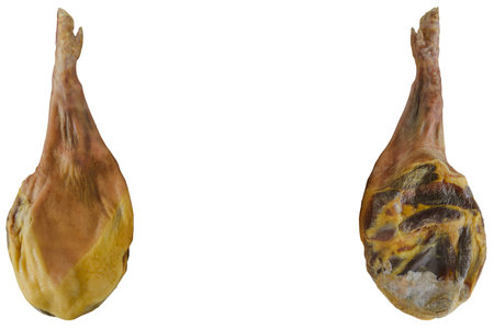 paws of two spanish dried hams (jamon) with space for text isolated on white backgroundの写真素材