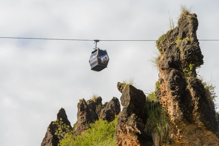 cable car cabin with people inside on the sky backgroundの写真素材