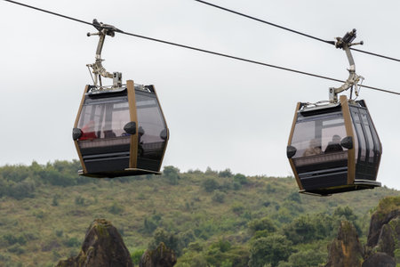 cable car cabin with people inside on the sky backgroundの写真素材