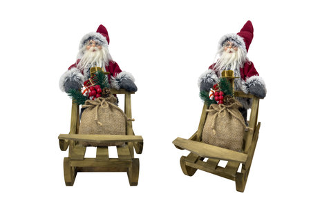 toy santa claus in wooden sleigh with sack of christmas gifts isolated on a white backgroundの写真素材