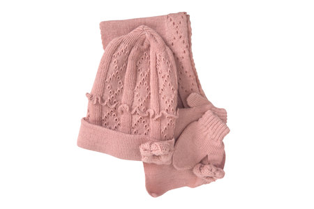 set of children's pink knitted clothes scarf, hat and mittens isolated on a white backgroundの写真素材