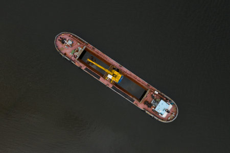 large ship is floating on the water. The ship is yellow and red