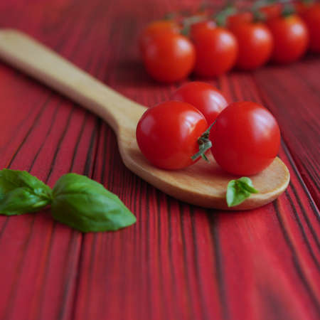 Tomatoes in a spoon on a wooden backgroundの写真素材