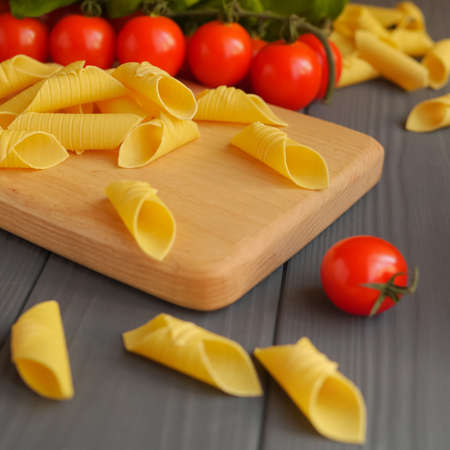 Garganelli pasta scattered on the kitchen boardの写真素材