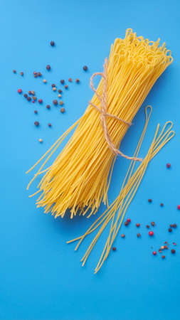 Tagliolini pasta on a blue backgroundの写真素材