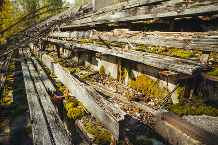 Old football stadium in Chornobyl exclusion zone. Radioactive zone in Pripyat city - abandoned ghost town. Chernobyl history of catastropheの写真素材