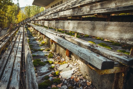Old football stadium in Chornobyl exclusion zone. Radioactive zone in Pripyat city - abandoned ghost town. Chernobyl history of catastropheの写真素材