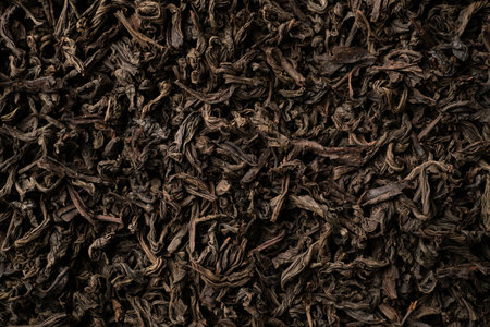Background of black loose-leaf tea. Close up, top viewの写真素材