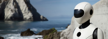 A humanoid robot stands on rocky terrain by the ocean, gazing at the waves and cliffs.の素材