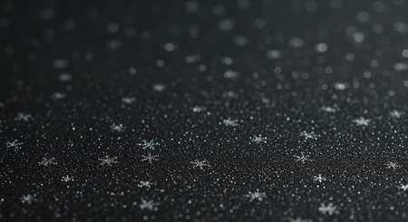 The close-up perspective highlights numerous shimmering silver snowflakes and fine glitter against a deep gray backdrop, with a shallow depth of field enhancing the sparkling, celebratory atmosphere.の素材