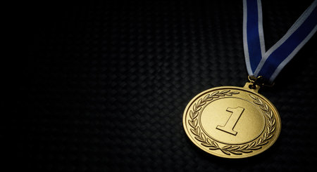 This close-up view features a gleaming first-place achievement medal with a prominent number one, set against a deep black woven pattern background, offering ample copy space.の素材