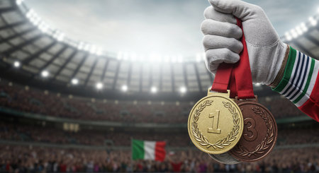 A close-up view captures a hand in a white glove with Italian flag stripes, holding gold, silver, and bronze medals, set against a vibrant, blurred stadium with spectators and a national flag.の素材