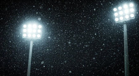 The intense glow from modern sports arena lighting poles cuts through the dense, falling snow, emphasizing the icy weather conditions and isolation.の素材