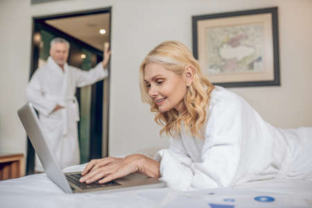 Couple in bath robes spending a day in a hotel relaxingの写真素材