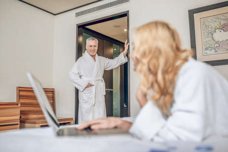 Couple in bath robes spending a day in a hotel relaxingの写真素材